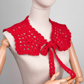 Red crochet top on a mannequin against a gray background