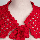 Red crochet collar on a mannequin with a neutral background
