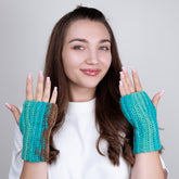 Woman wearing teal fingerless gloves against a plain background